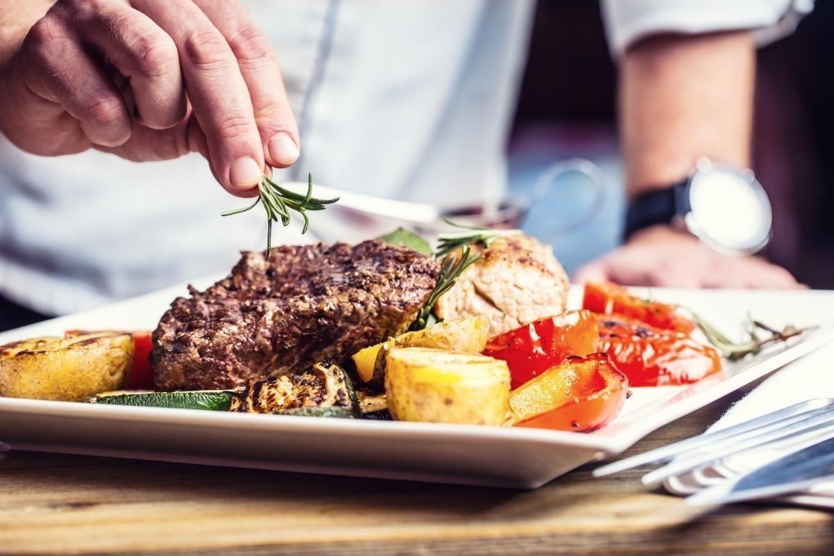Chef serving an elegant plated dinner